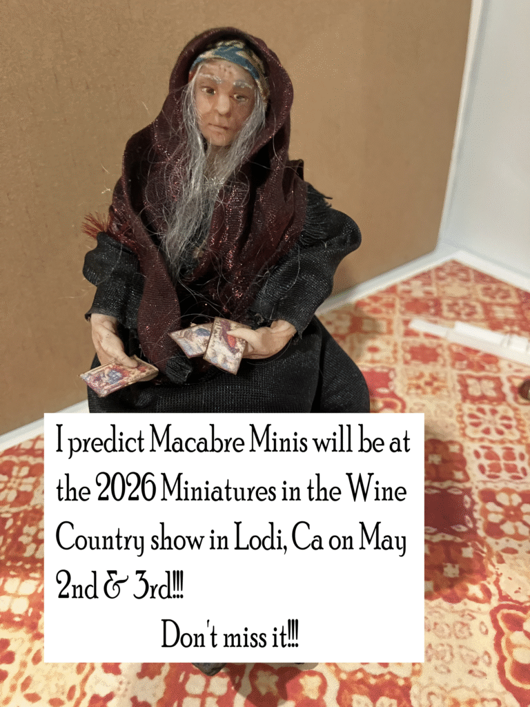 Image of handmade polymer fortuneteller doll made by Cherie's Macabre Minis with the text, "I predict Macabre Minis will be at the Miniatures in the Wine Country show in Lodi CA on May 2nd and 3rd.  Don't miss it!"